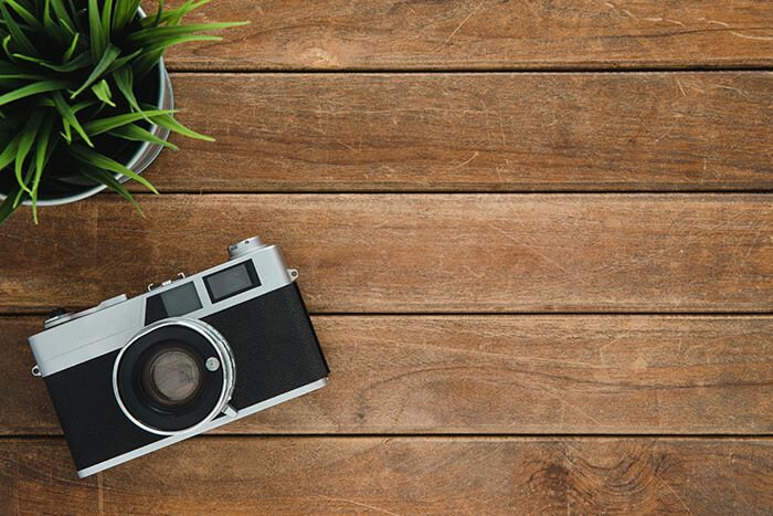 camera on top of a wooden floorboard