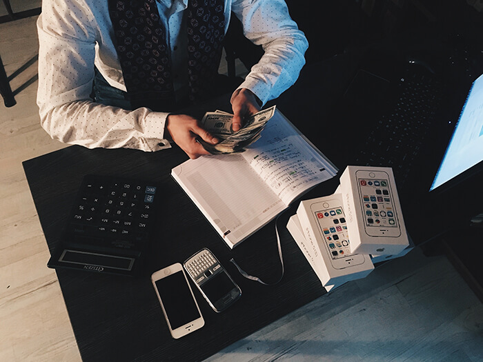 man in suit counting money