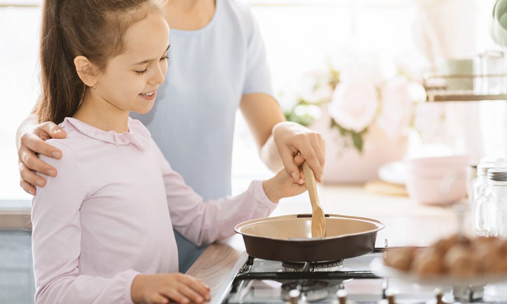 mother and daughter cooking