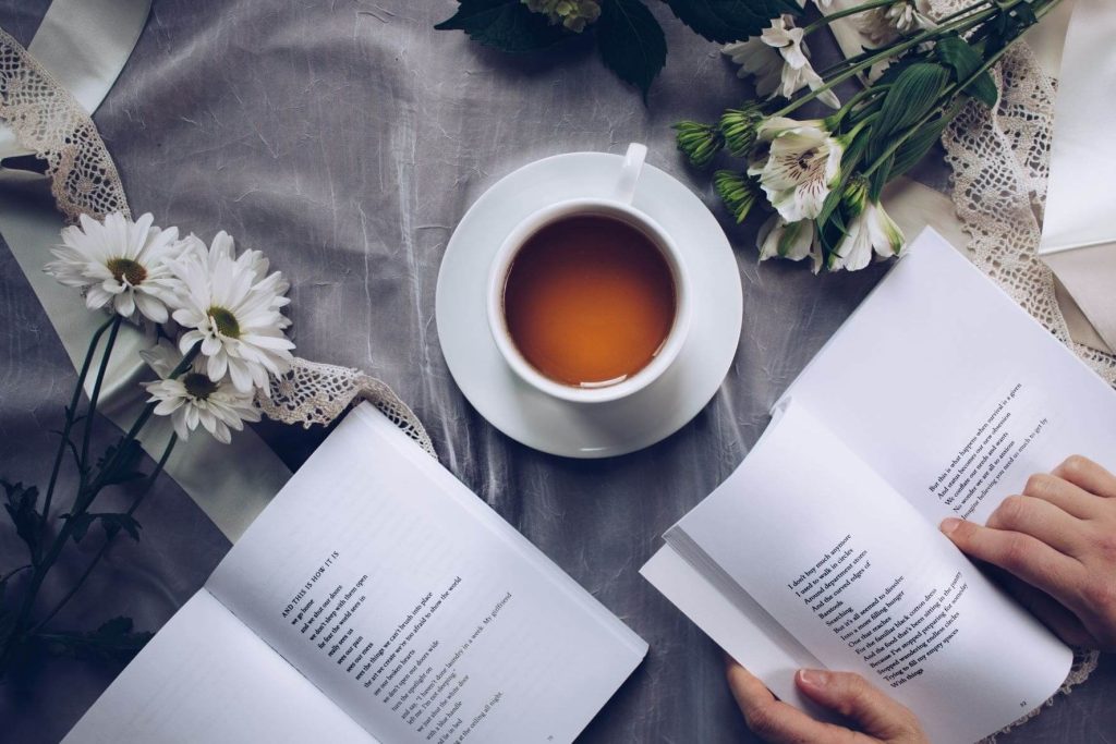 photo of a cup of tea with books on a christmas day