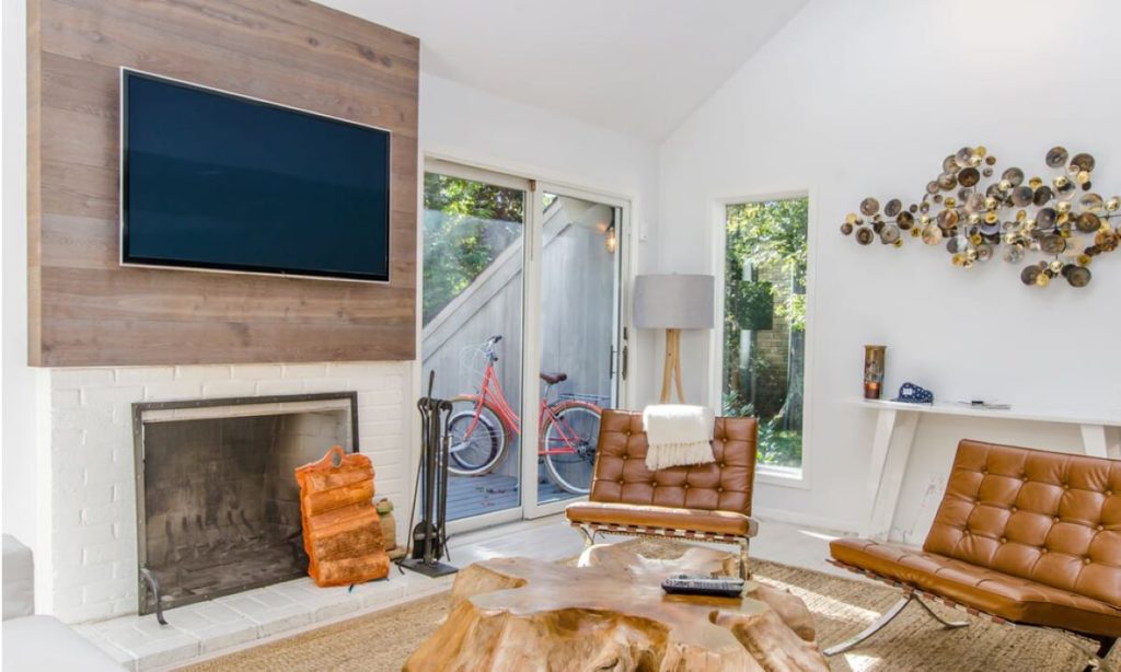 photo of a livingroom with a tv on the wall
