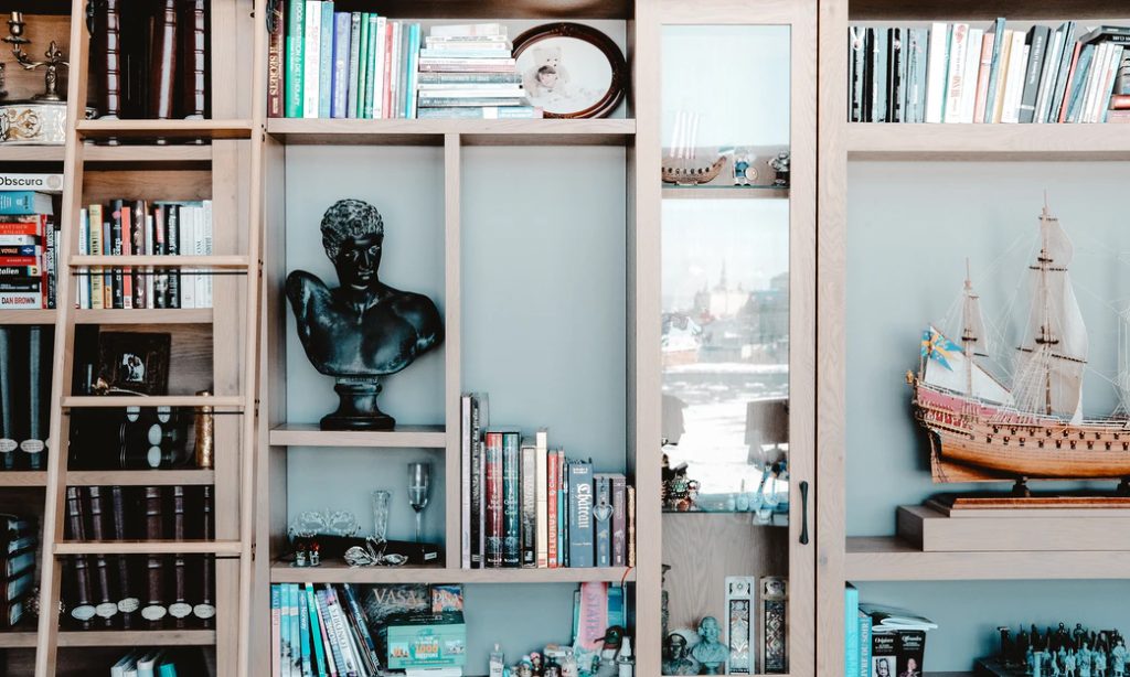 photo of an organized shelf with a statue