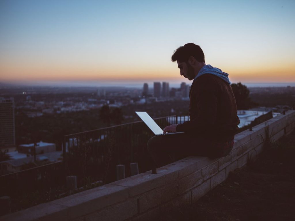 Man-on-roof-with-a-laptop