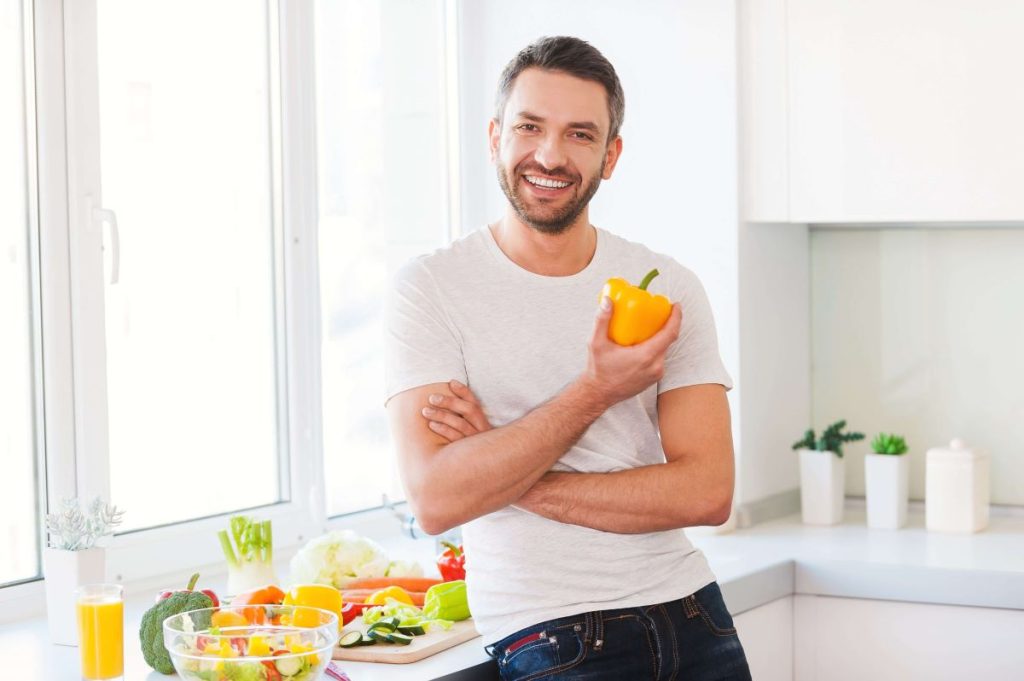 Person holding a vegetable