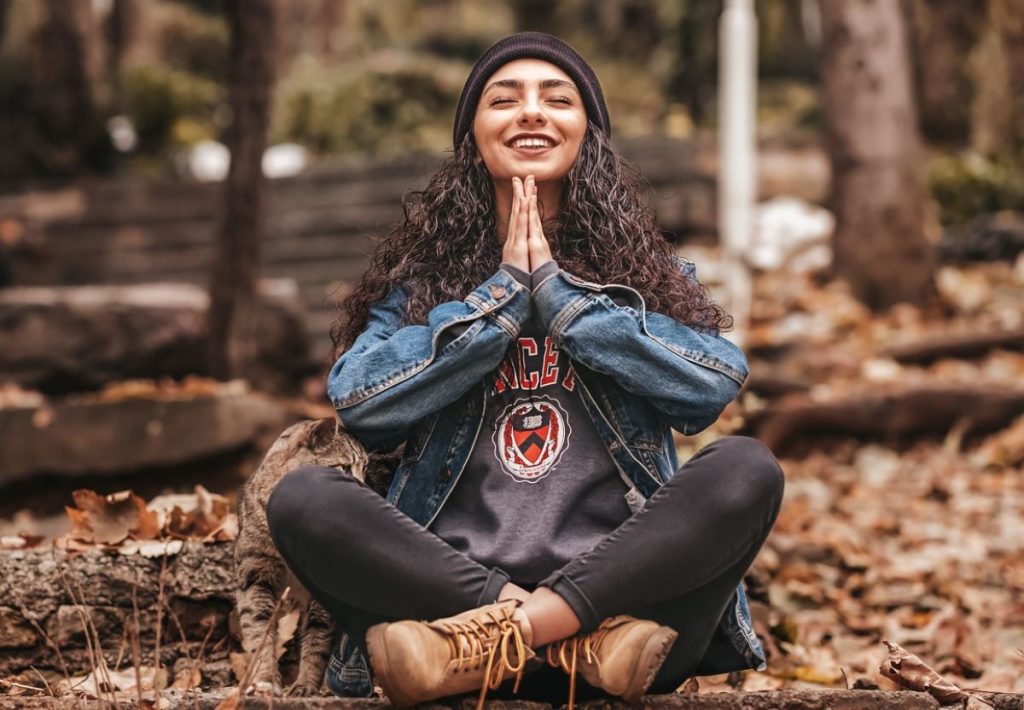 photo of a woman meditating in the forest