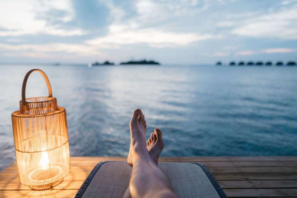 a photo of a person relaxing by the lake