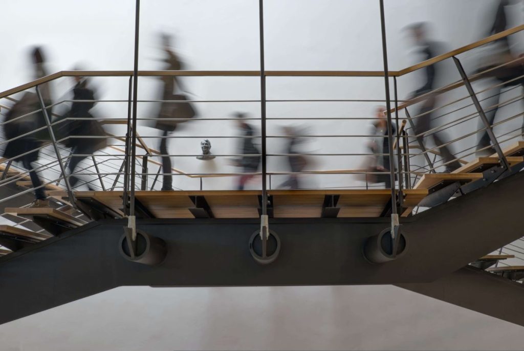 a timelapsed photo of students walking on the stairs