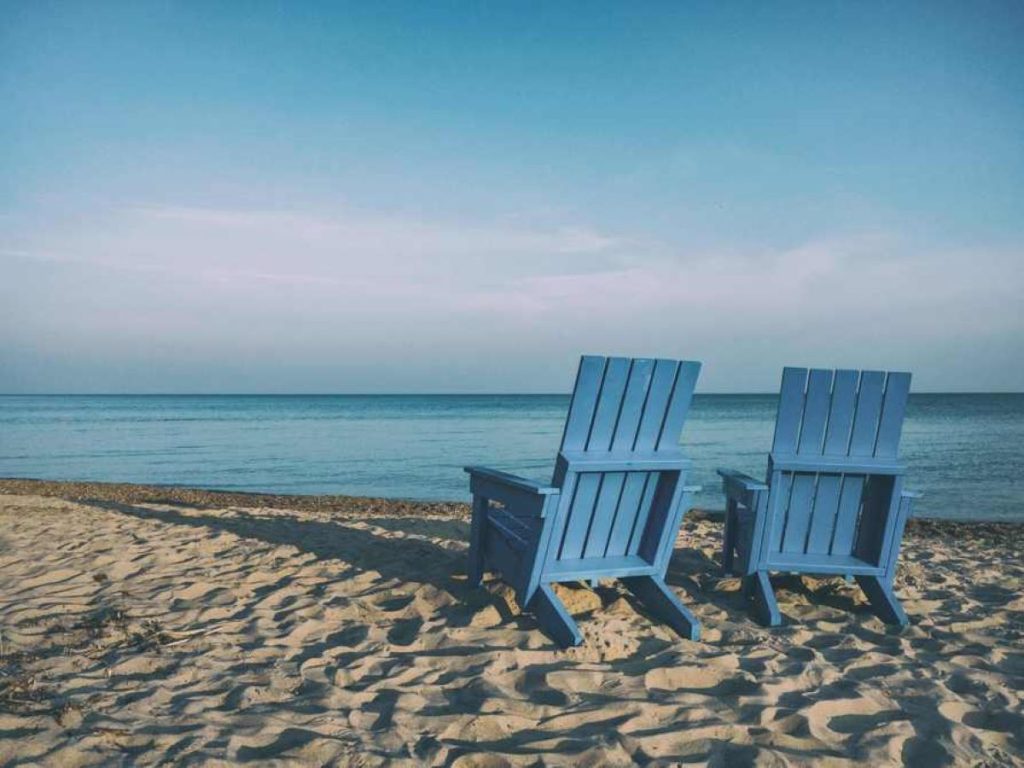 photo of a beach with blue seats