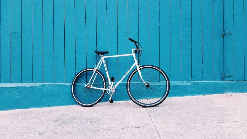 photo of a bike resting on a wall