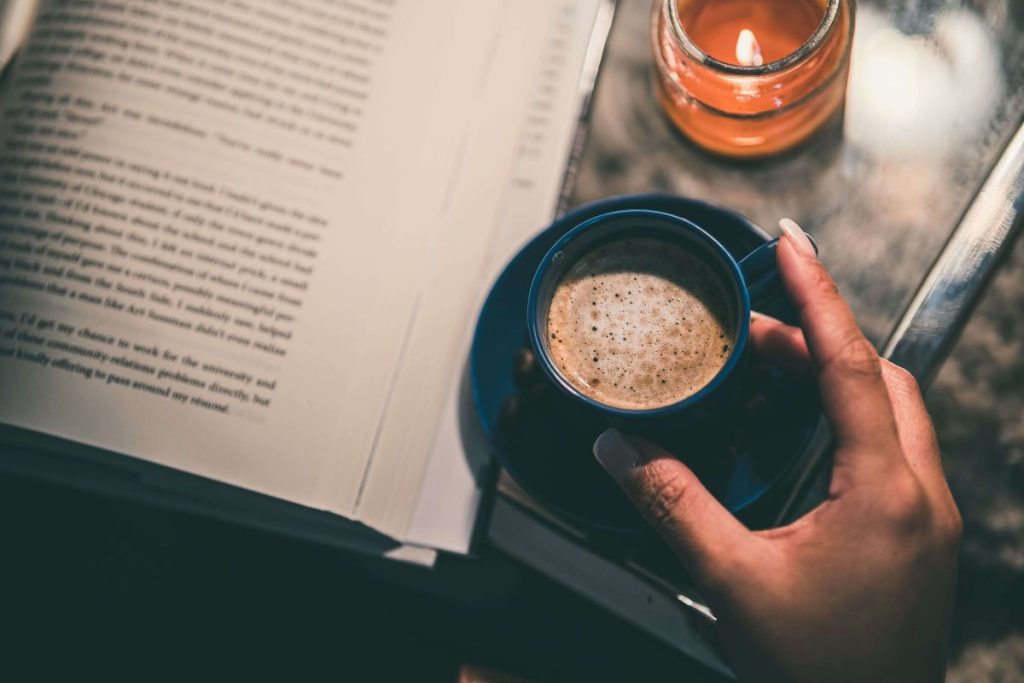photo of a book and a cup of coffee