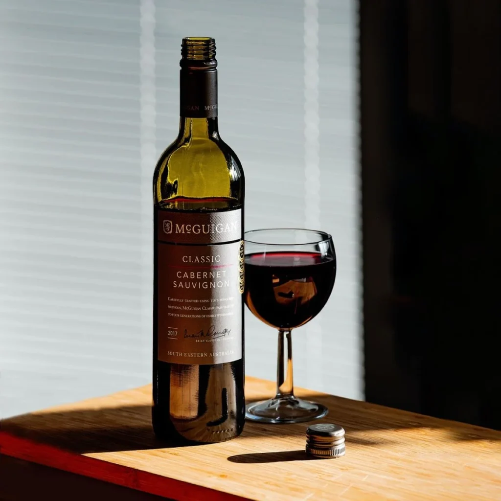 photo of a bottle and glass of red wine