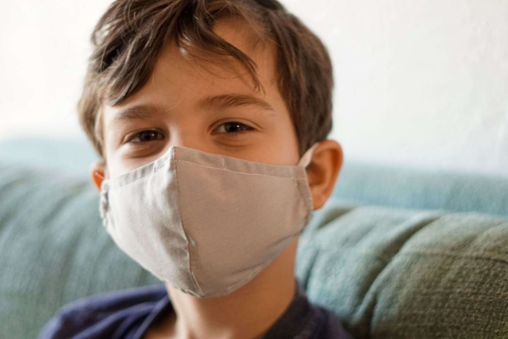photo of a boy wearing a face mask