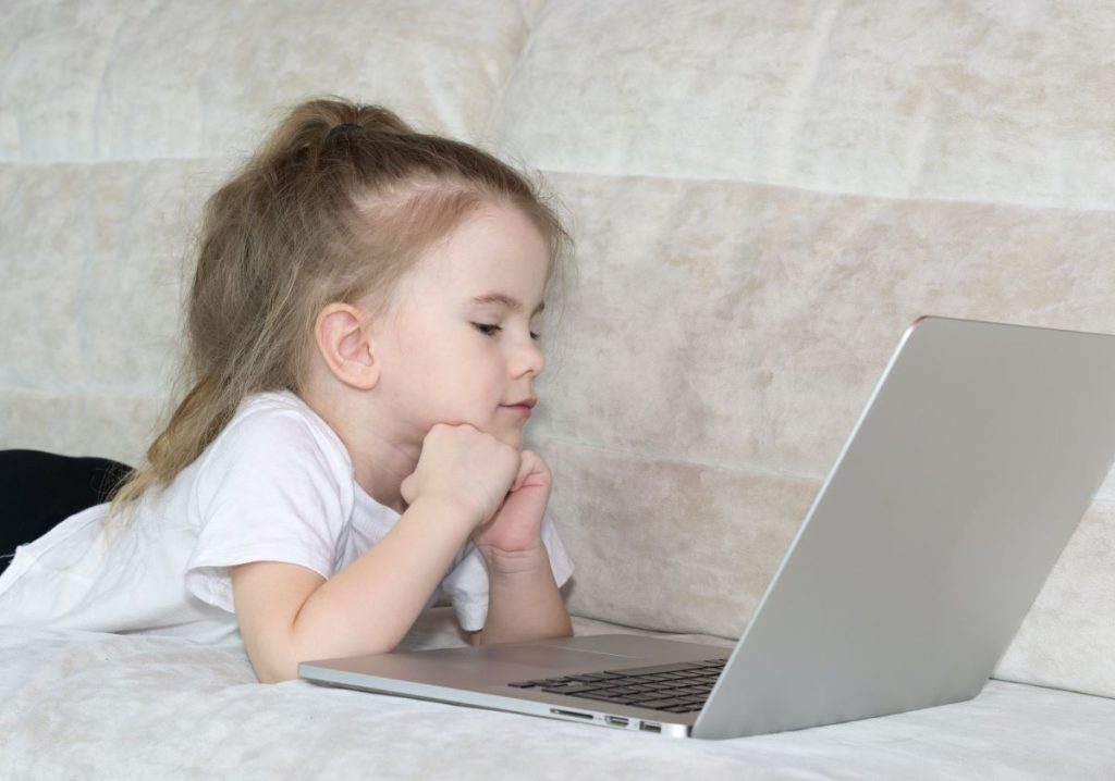 photo of a child using a laptop