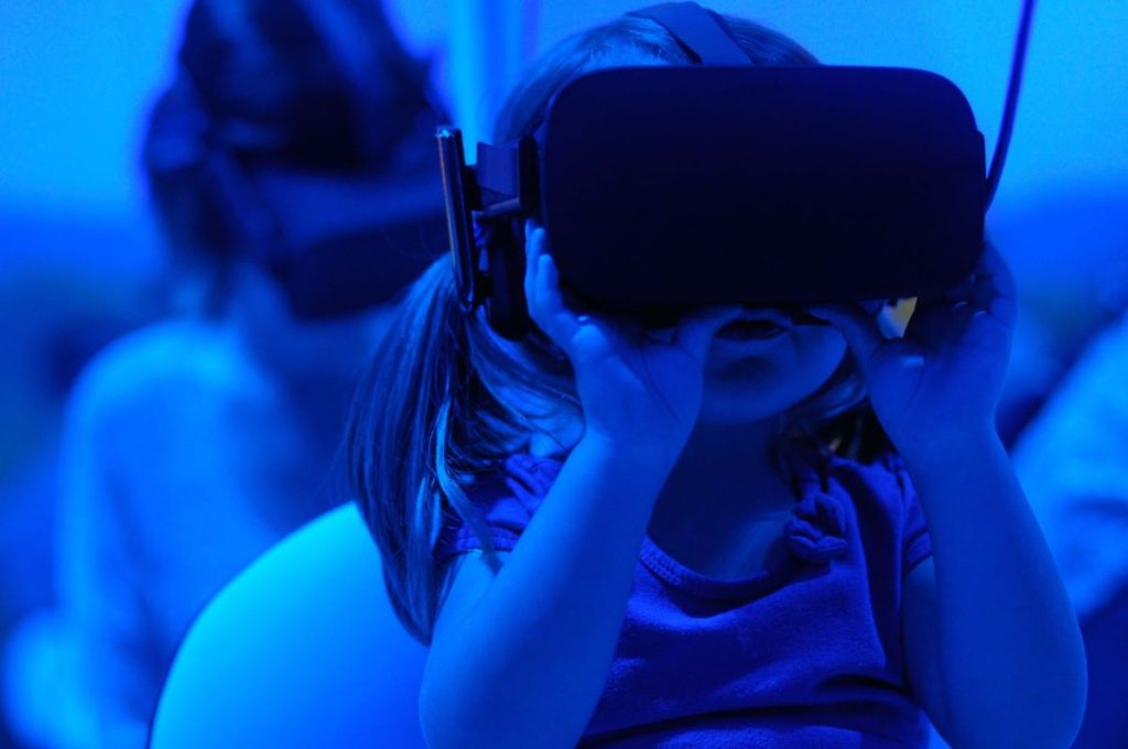 photo of a child wearing a Virtual Reality glasses