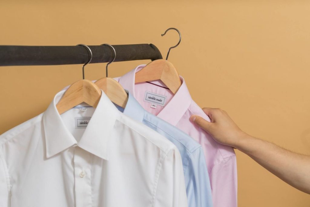 photo of a clothing rack with pressed shirts
