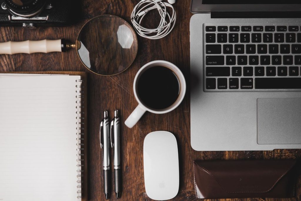 photo of a computer set up with a laptop and coffee