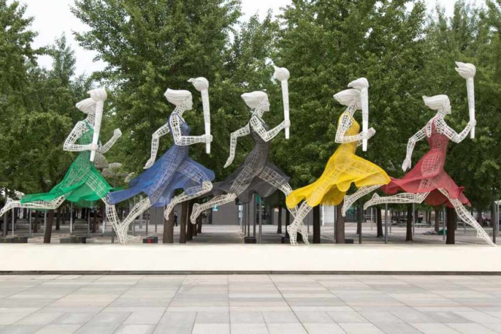 photo of a contemporary art of women carrying a torch wearing the olympics colors