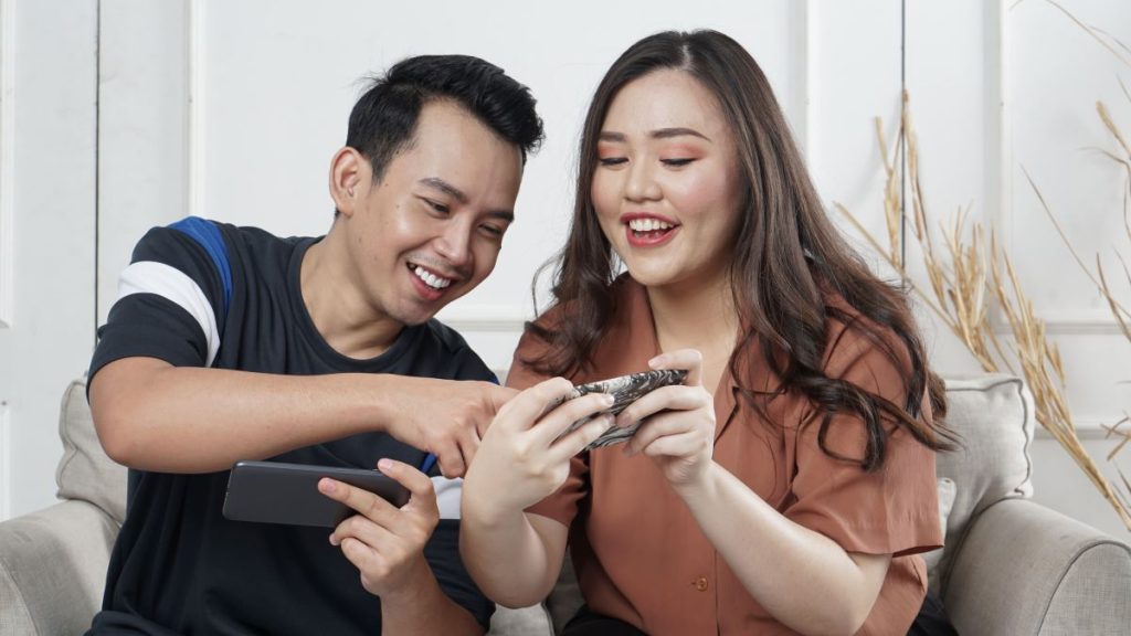 photo of a couple playing a mobile game