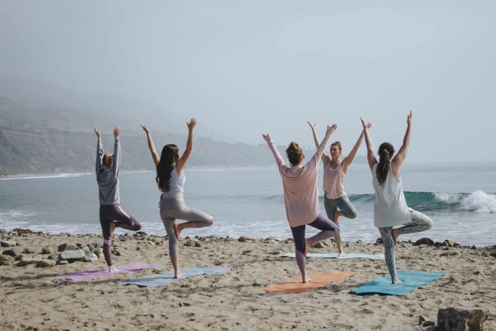 photo of a group of people doing yoga