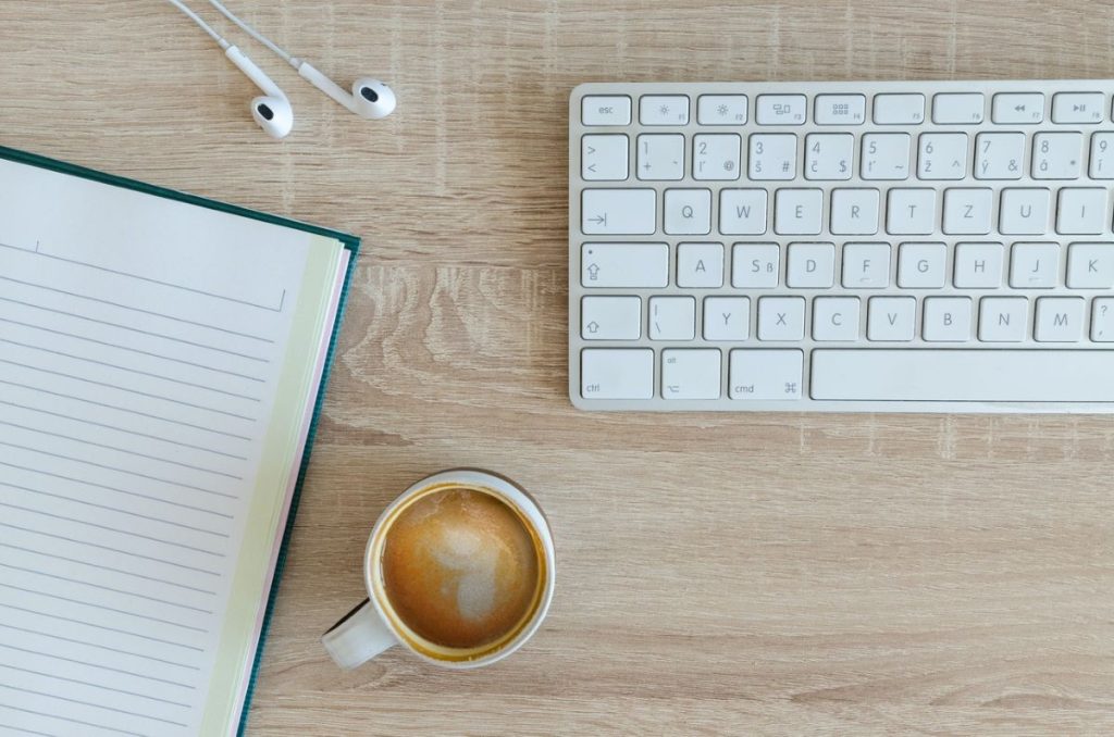 photo of a keyboard and coffee