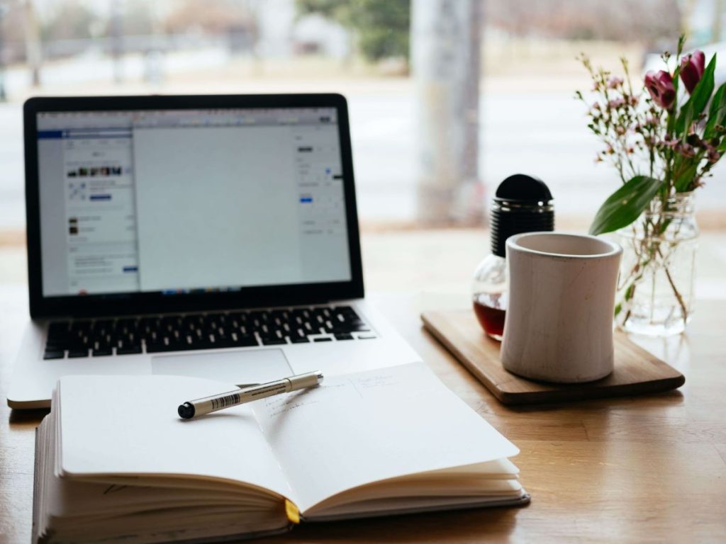 photo of a laptop with an open diary planner