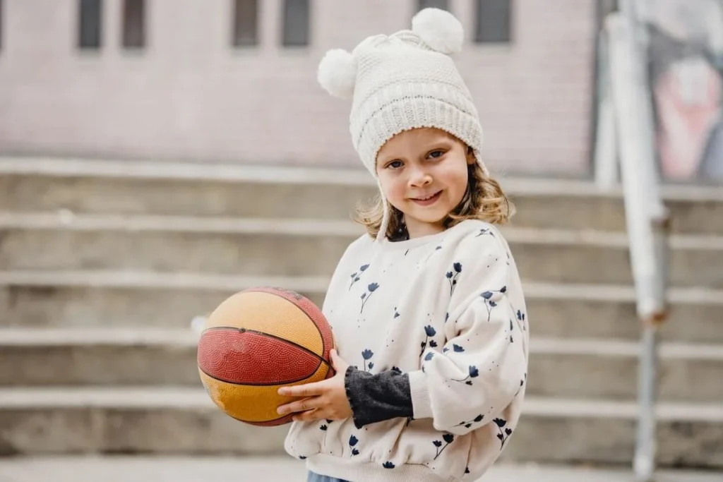 photo of a little girl holding a basketball