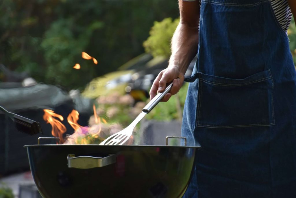 photo of a man cooking a barbeque