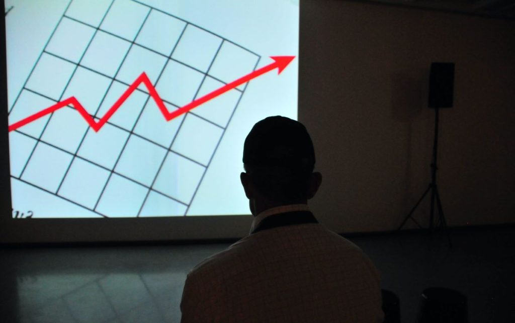 photo of a man looking at a graph