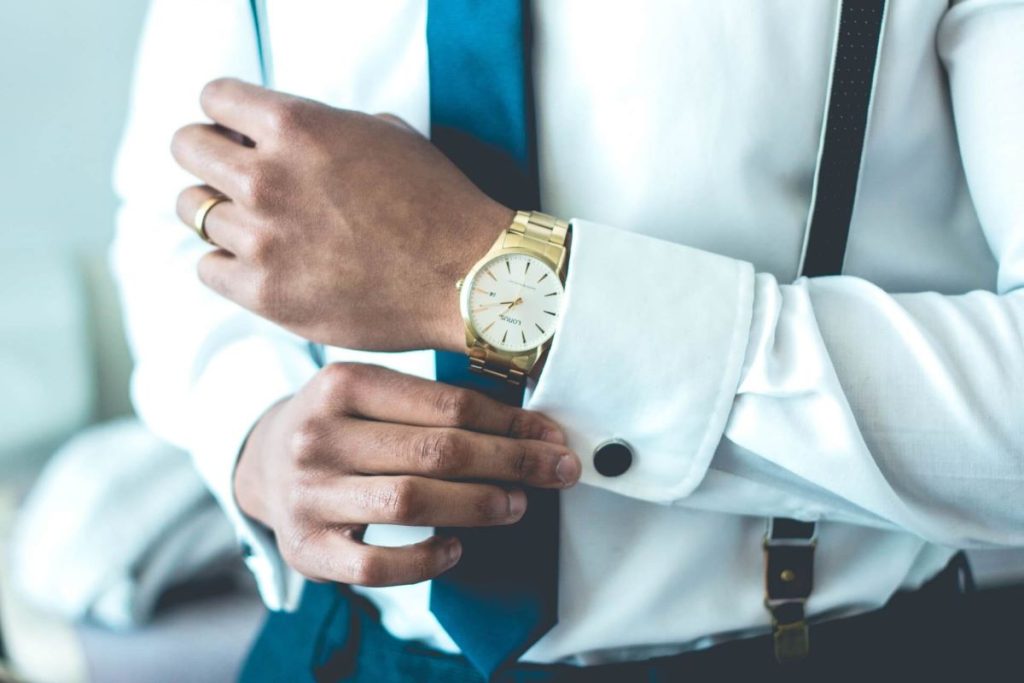 photo of a man wearing a gold watch