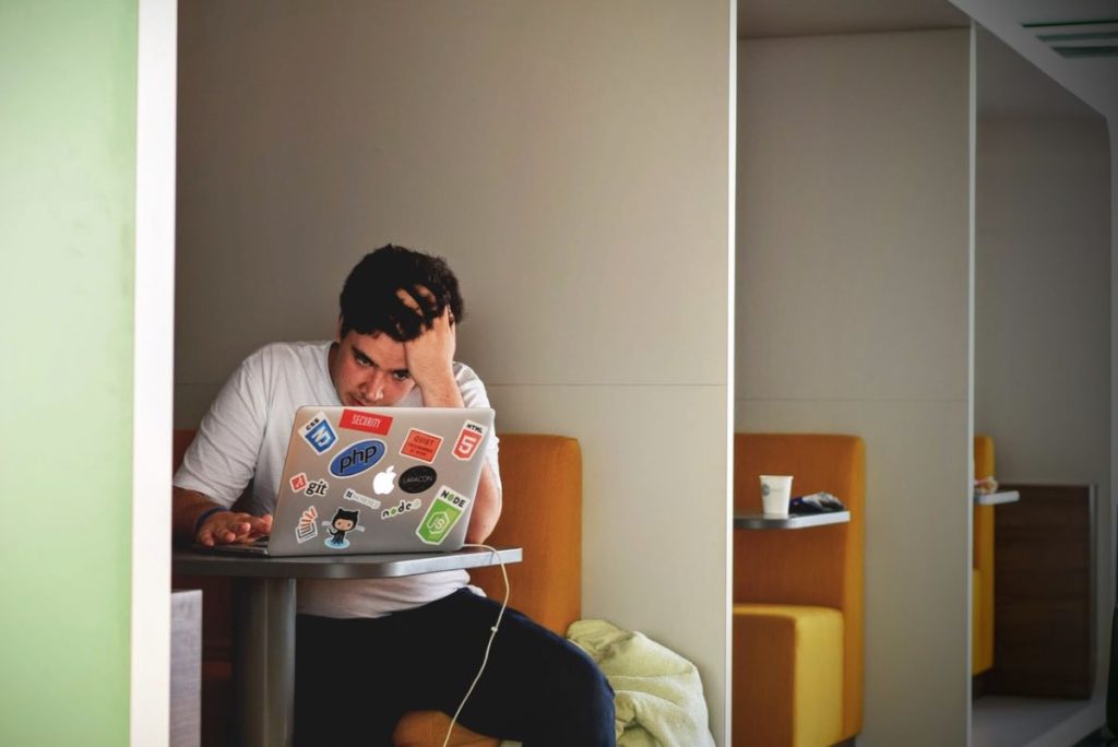 photo of a man working on his laptop