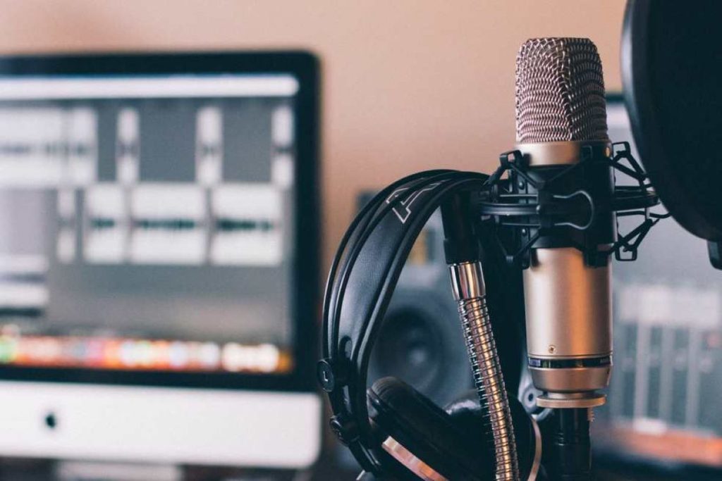 photo of a microphone and headset in a recording studio