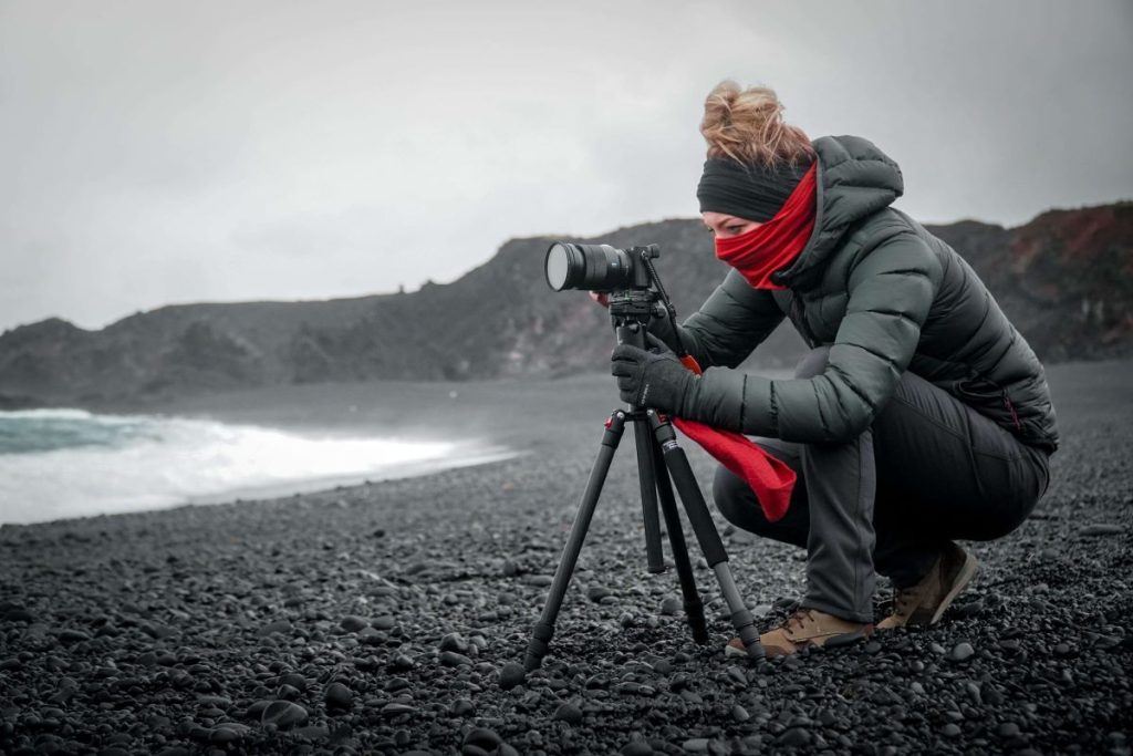 photo of a nature photographer taking a shot in the beach