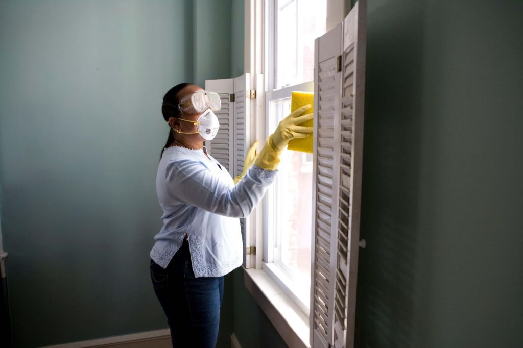 photo of a person cleaning a window