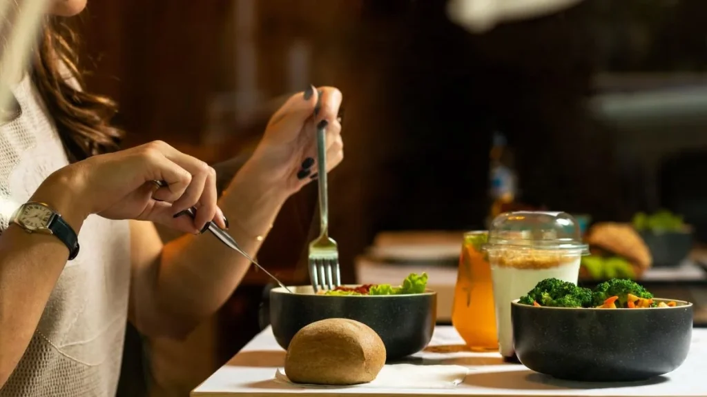 photo of a person eating a salad