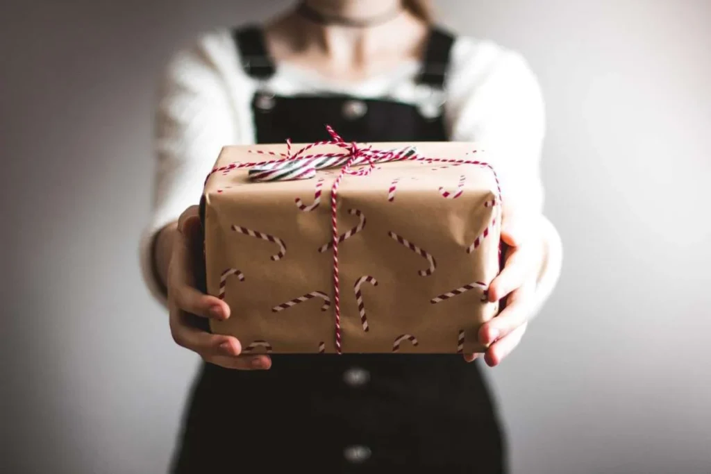 photo of a person handing out a christmas gift