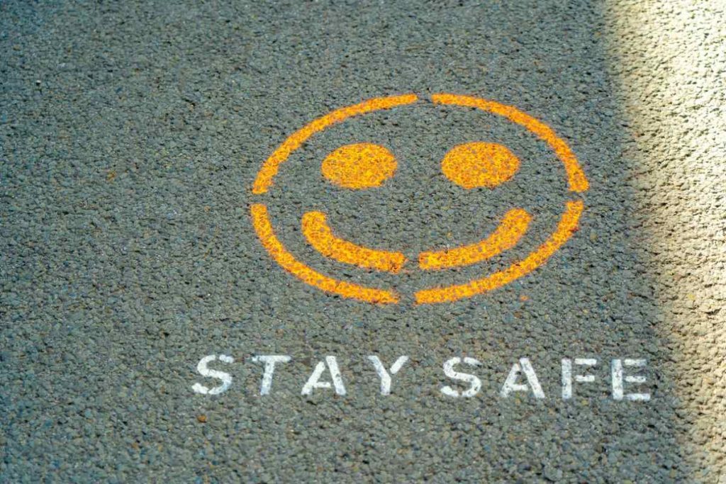photo-of-a-road-with-a-reminder-to-stay-safe
