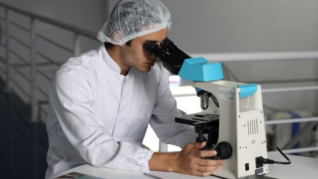 photo of a scientist looking into a microscope