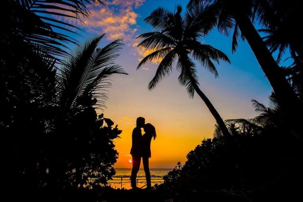 photo of a silhouette of a couple with a sunset view