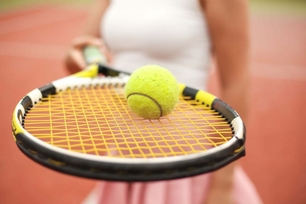 photo of a tennis ball on a tennis racket