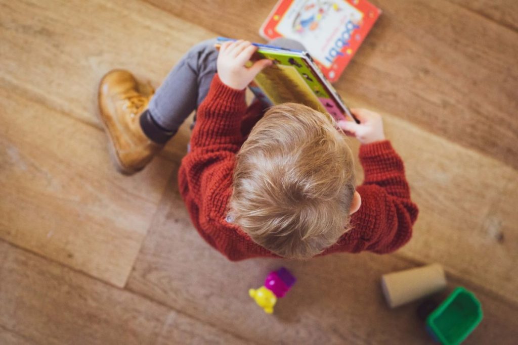 photo of a toddler with his toy