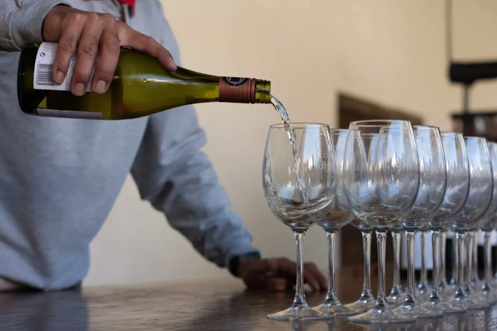 photo of a wine being poured into a glass