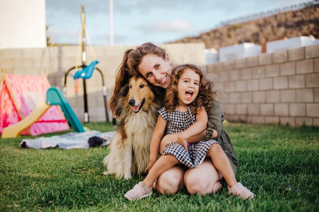 photo of a woman and a child with their pet dog