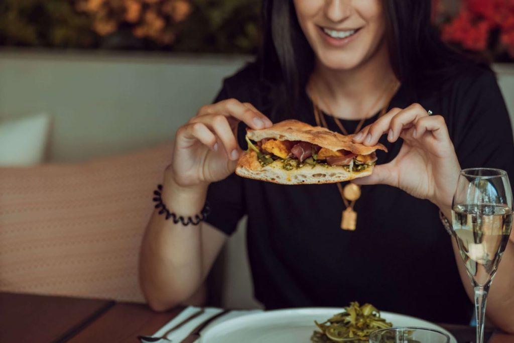 photo of a woman eating a sandwich