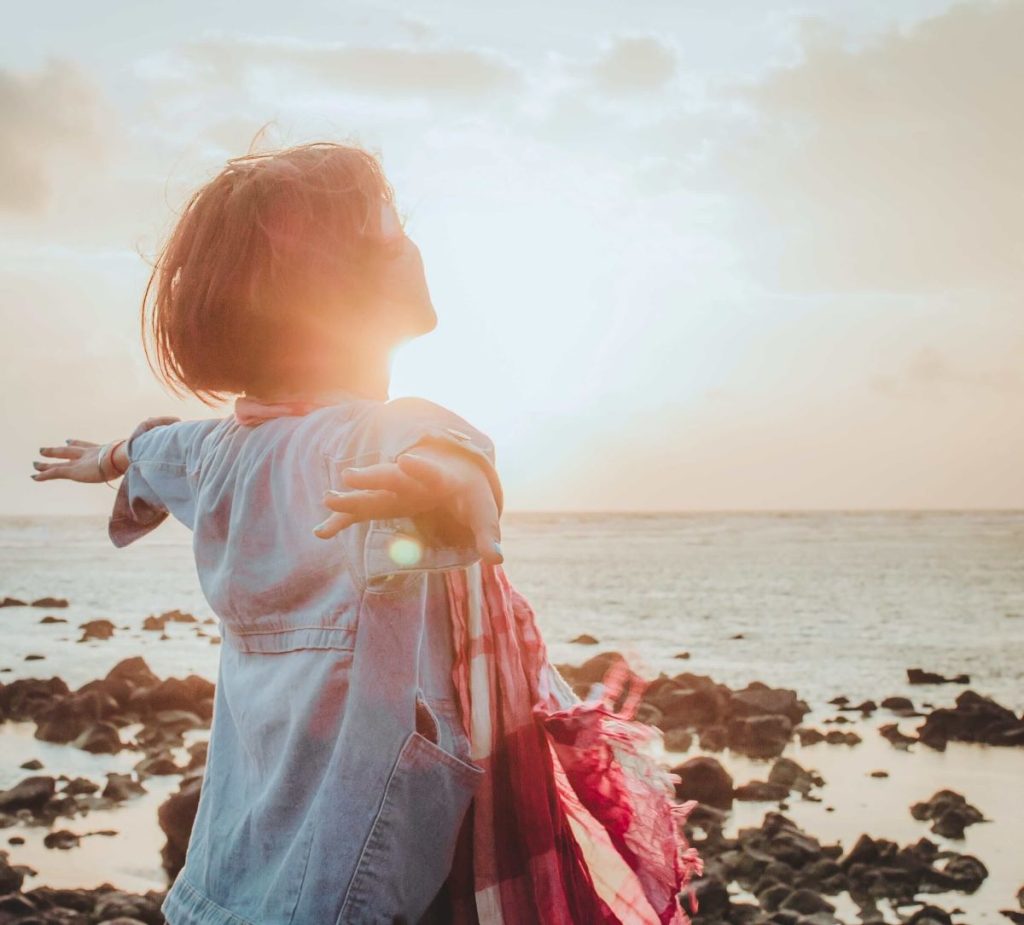 photo of a woman enjoying the sunset