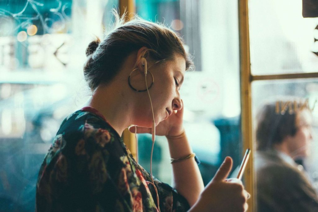 photo of a woman listening intently to a podcast
