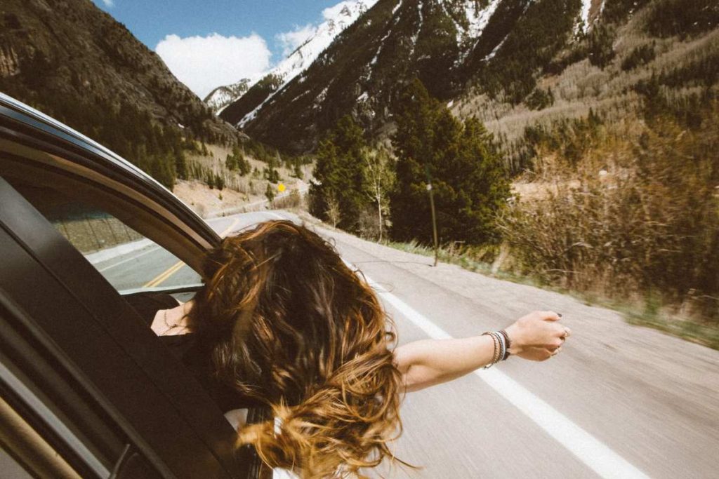 photo of a woman looking out a car window