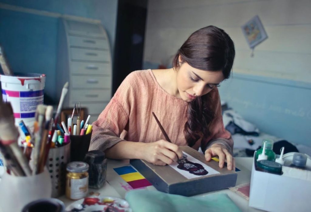 photo of a woman painting