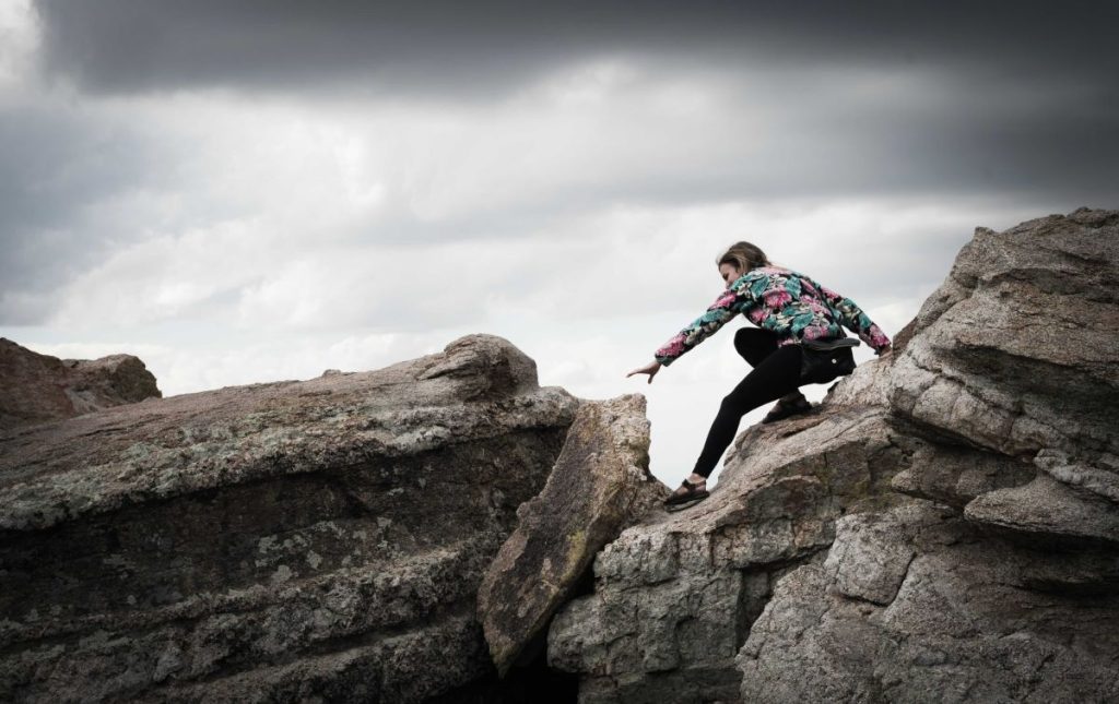 photo of a woman rock climbing
