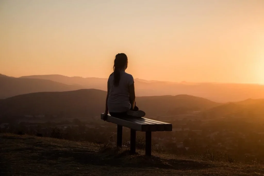 photo of a woman sitting on a bench