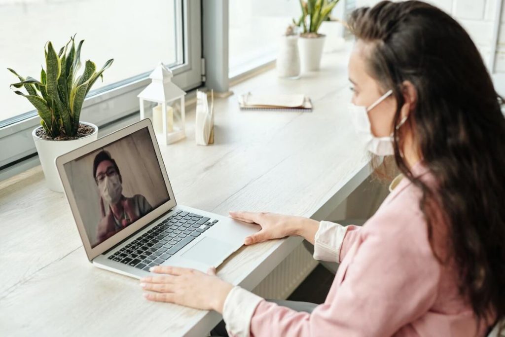 photo of a woman working from home and is having a zoom meeting